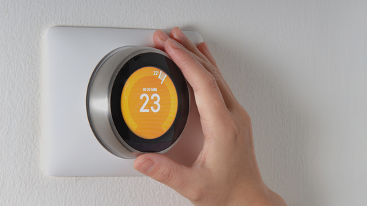 Hand on Smart thermostat