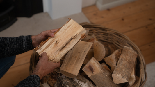 Homefire Firewood. What is the better choice? Main holding Homefire kiln-dried firewood logs above basket.